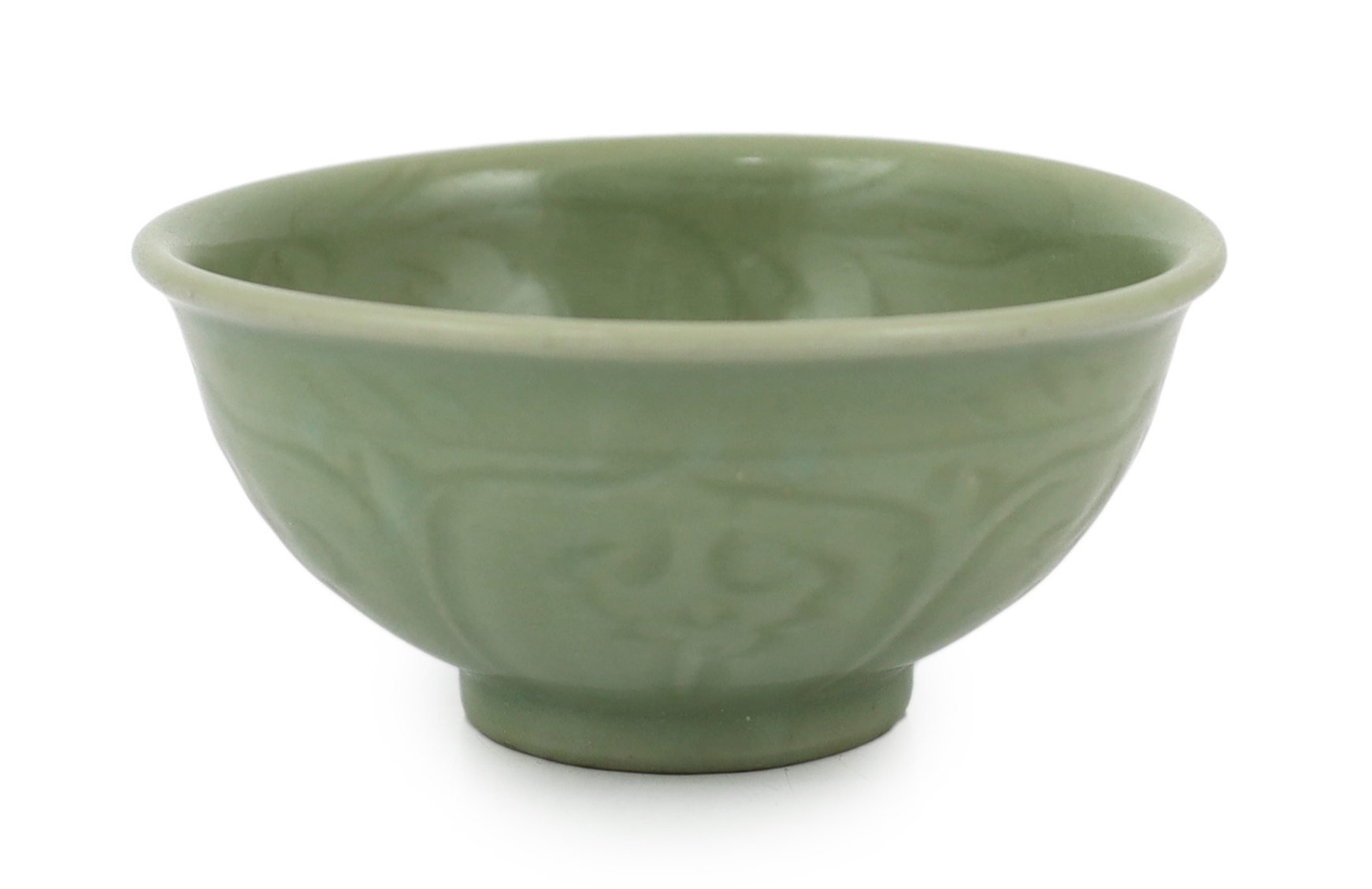 A Chinese Longquan celadon bowl, the interior carved with lotus flowers and the exterior with foliate lappets, 15.2cm diameter., Provenance - Robert Ricketts collection, formerly sold by Robert McPherson, London and S. M